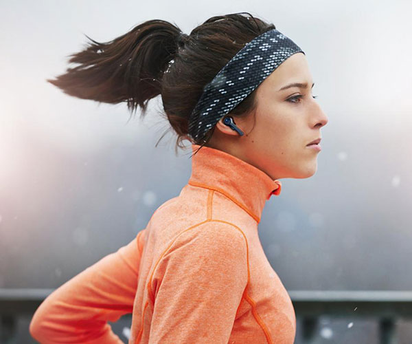 woman wears earbuds